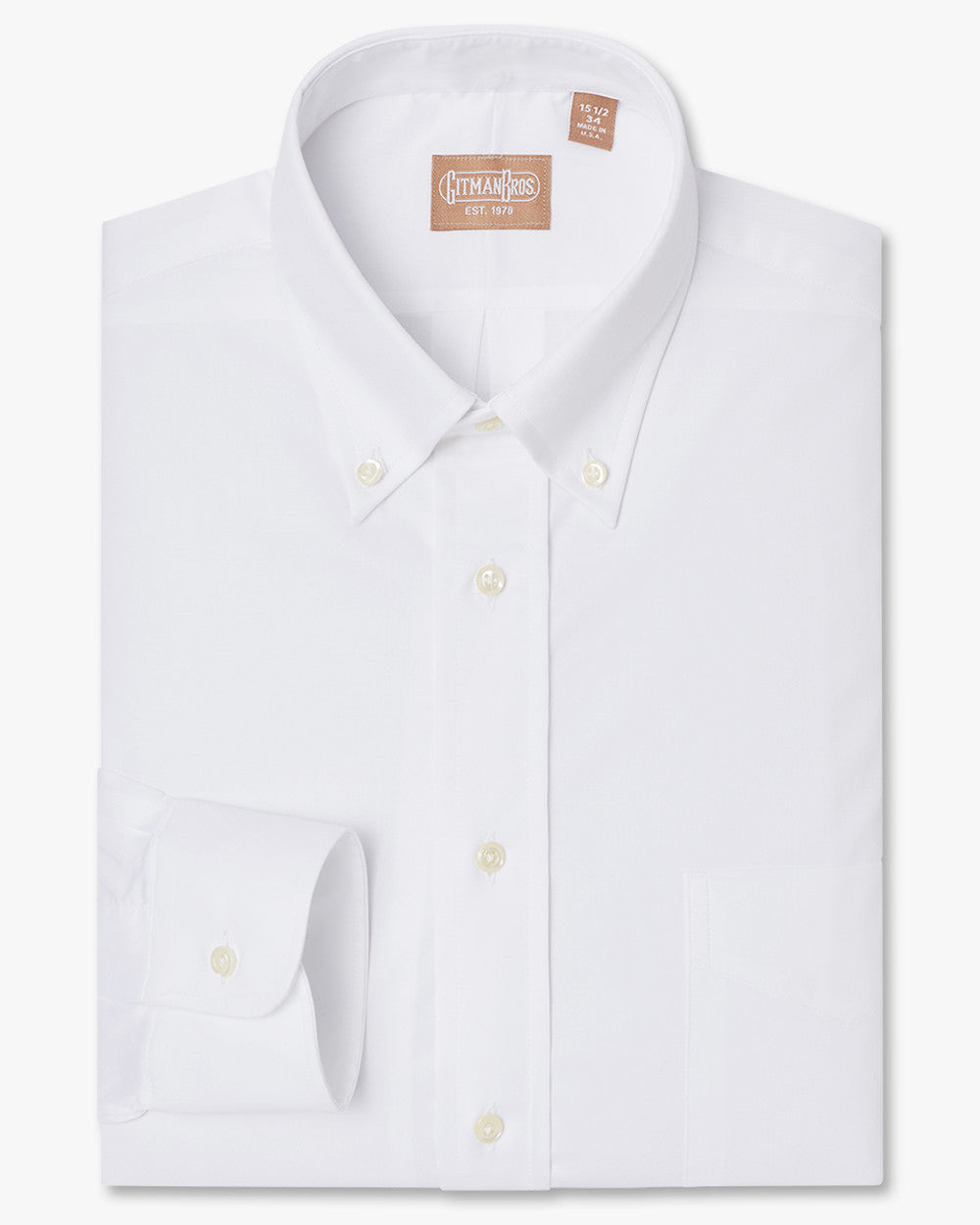A folded button down shirt with white buttons made from solid white miniature twill fabric