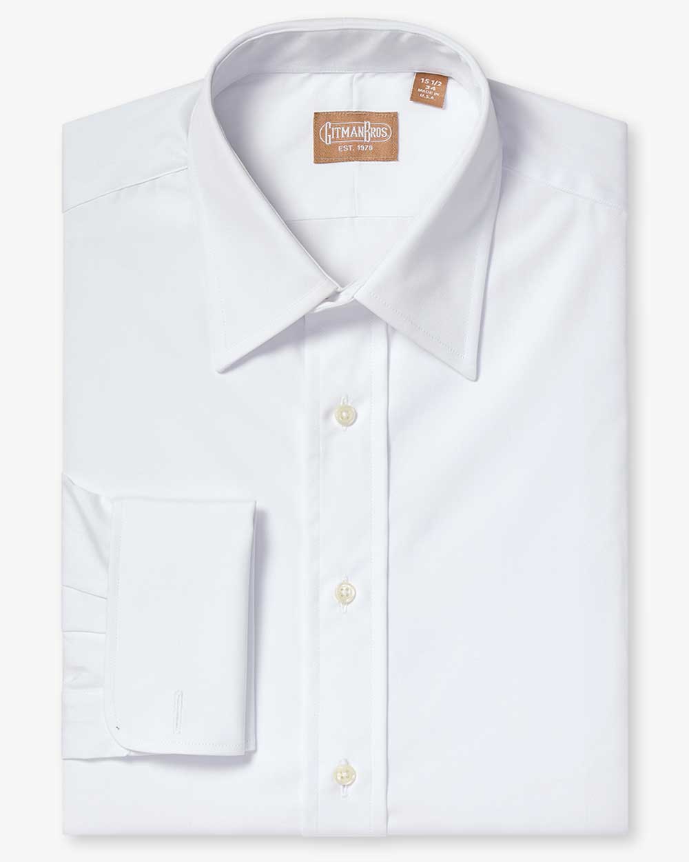 a folded medium spread shirt with french cuffs white buttons made from solid white broadcloth fabric