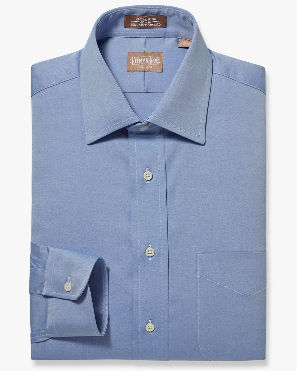 Folded button down shirt with white buttons and blue pinpoint fabric