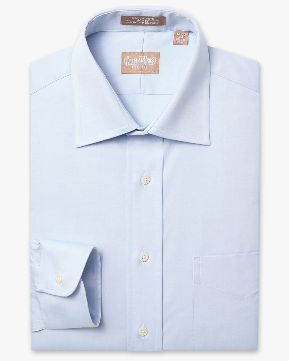 Folded button down shirt with white buttons and light blue fabric