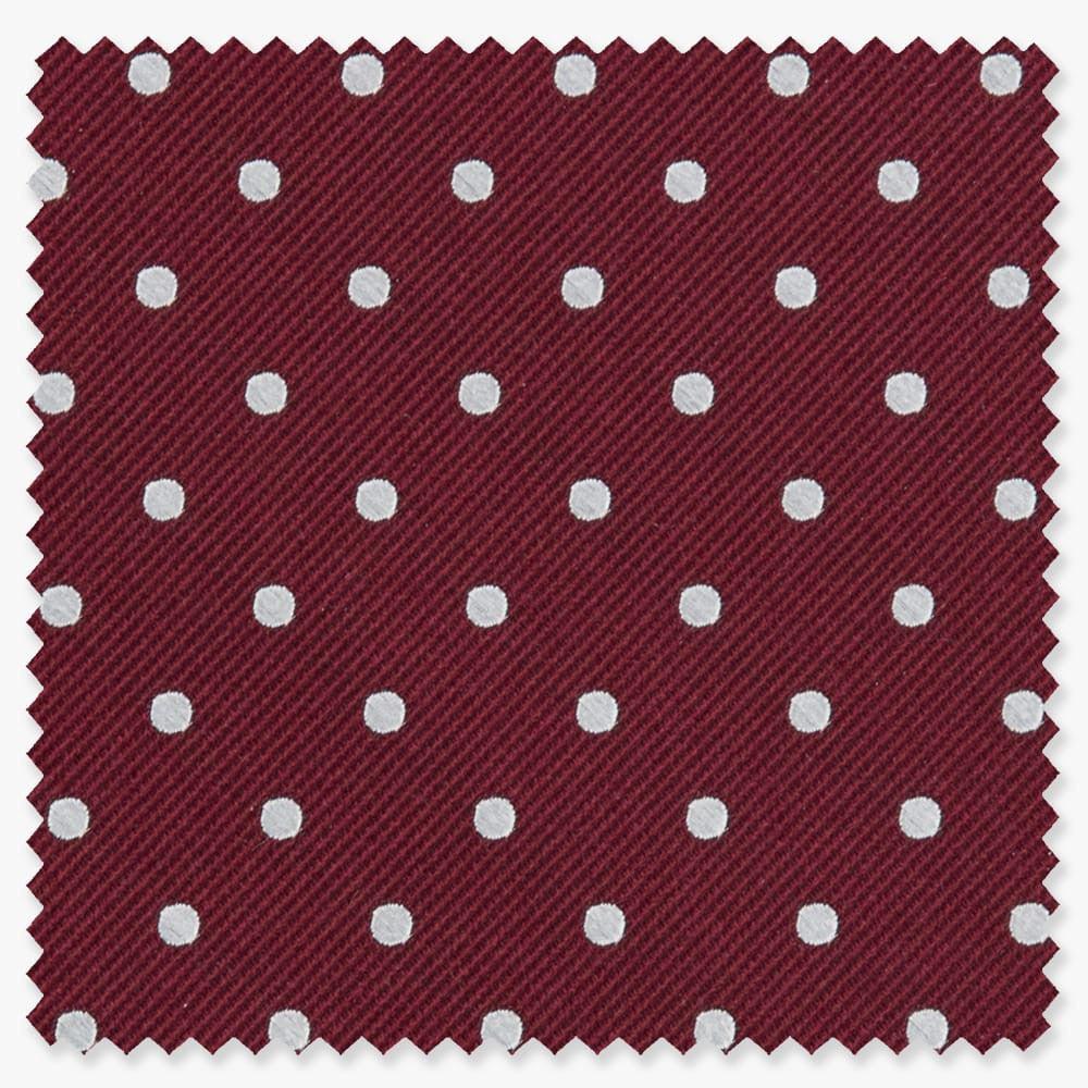 Swatch of burgundy tie fabric with white dots