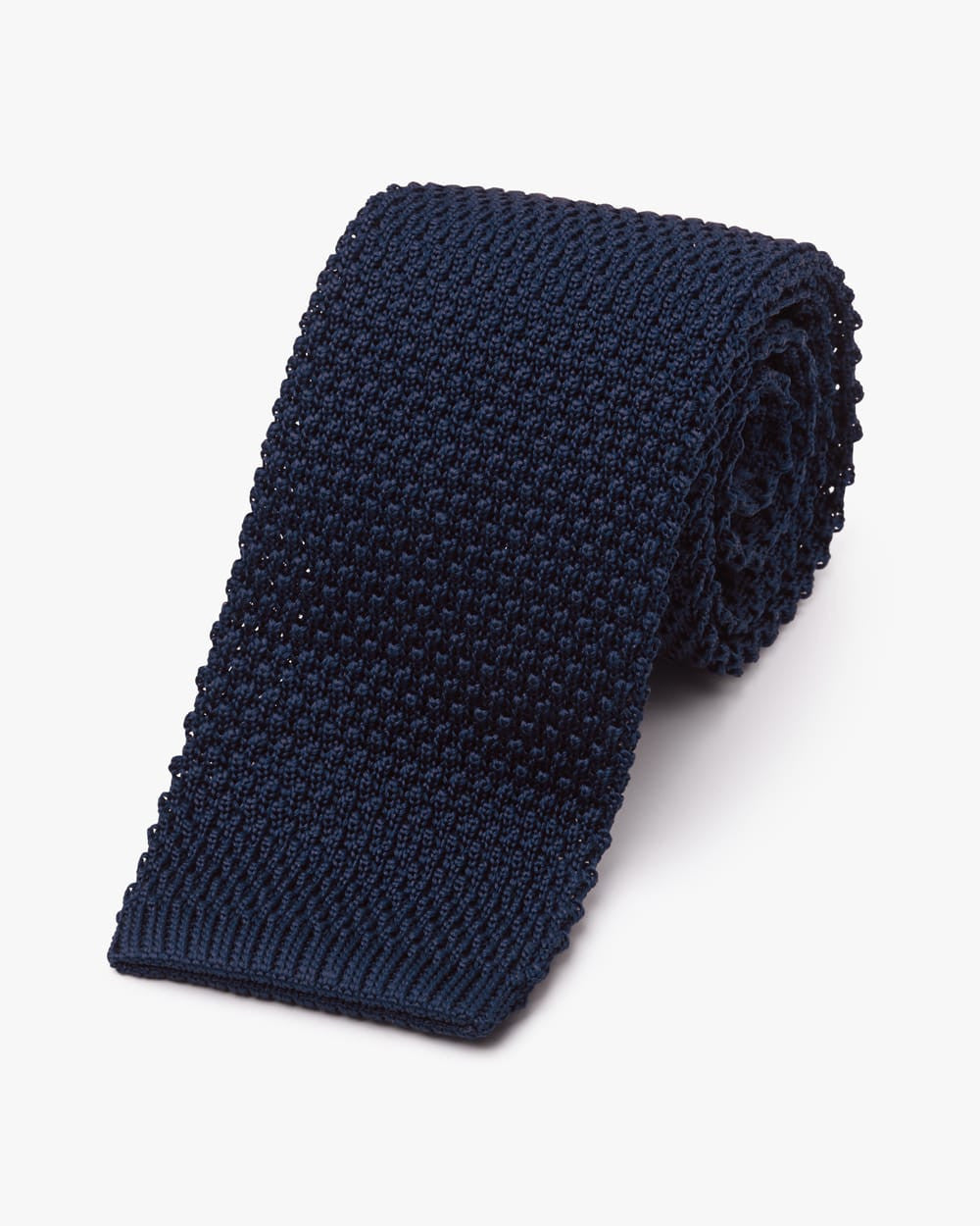 Rolled tie made of a navy knitted fabric and squared end