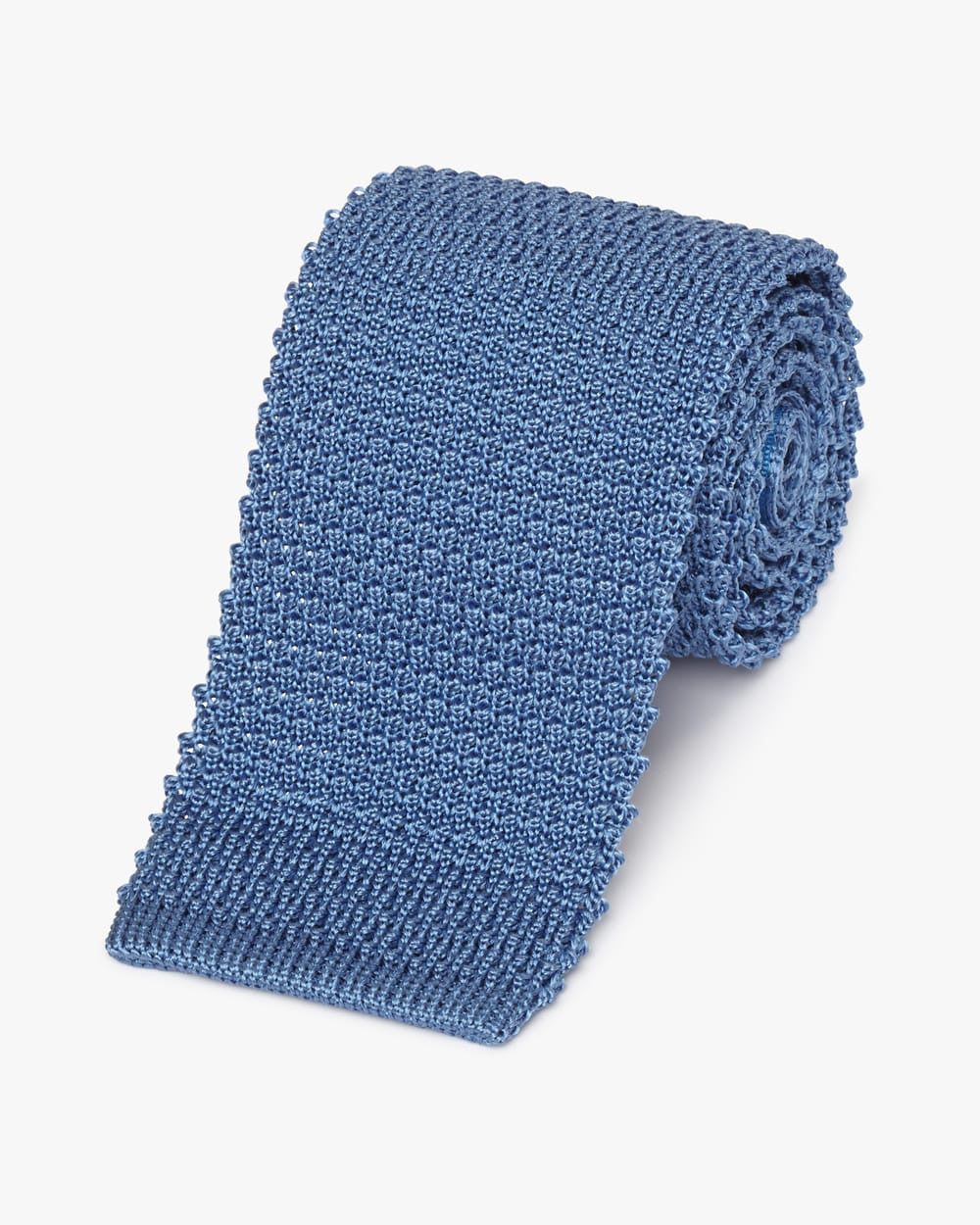Rolled tie made of a light blue knitted fabric and squared end