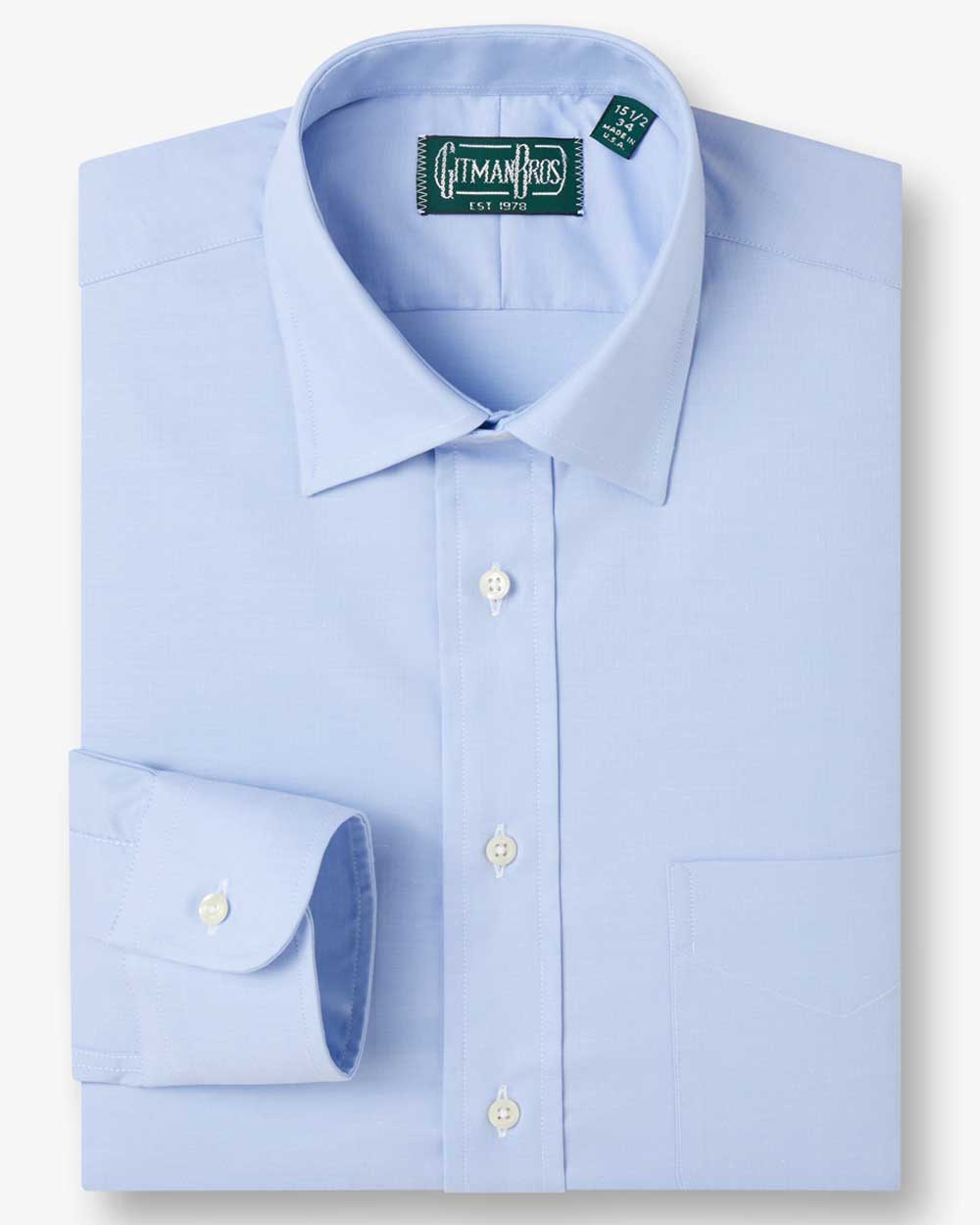 a folded medium spread shirt with white buttons made with solid light blue fabric