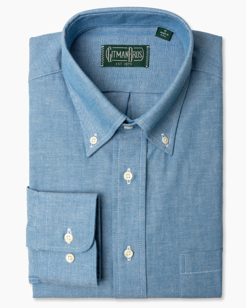 The Classic Chambray sport shirt, with a stitched placket, a button down collar, adjustable cuffs, and white buttons.
