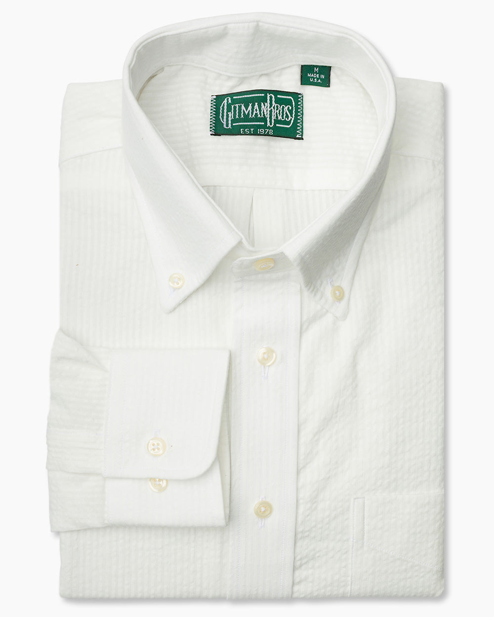The White Seersucker shirt with a button down collar and white buttons on a stitched placket.