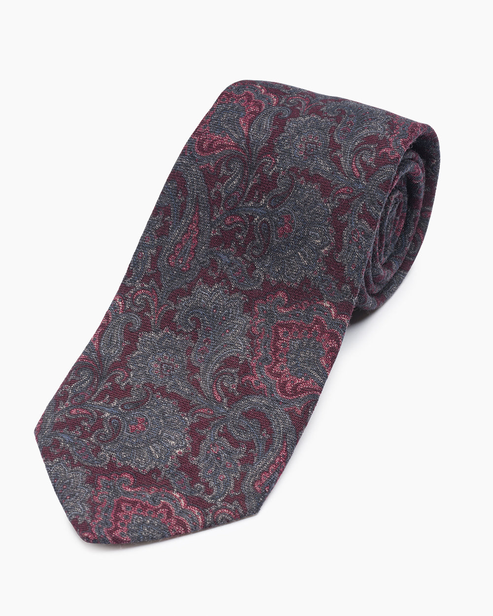 The Burgundy Paisley Tie, crafted from 100% wool and hand-sewn in North Carolina. A refined paisley pattern with rich tonal color, natural drape, and versatile appeal.