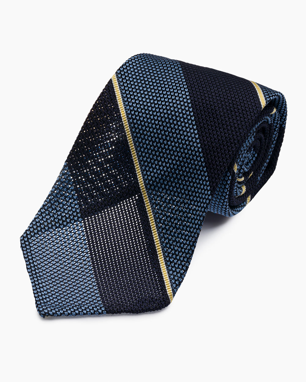 The Blue University Stripe Grenadine Tie features a classic striped pattern and textured weave, handmade in North Carolina.