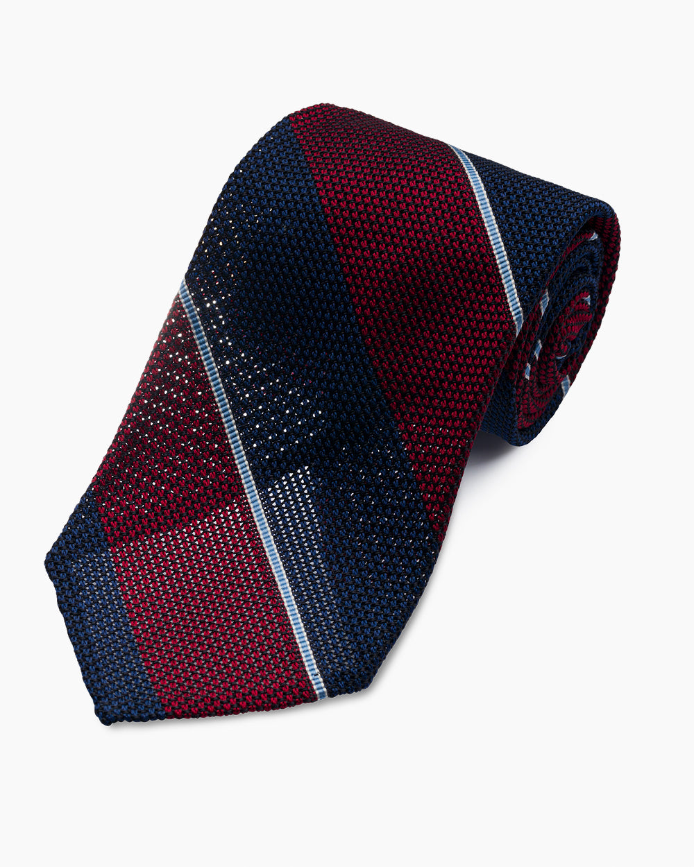 The Red University Stripe Grenadine Tie features a classic striped pattern and textured weave, handmade in North Carolina.