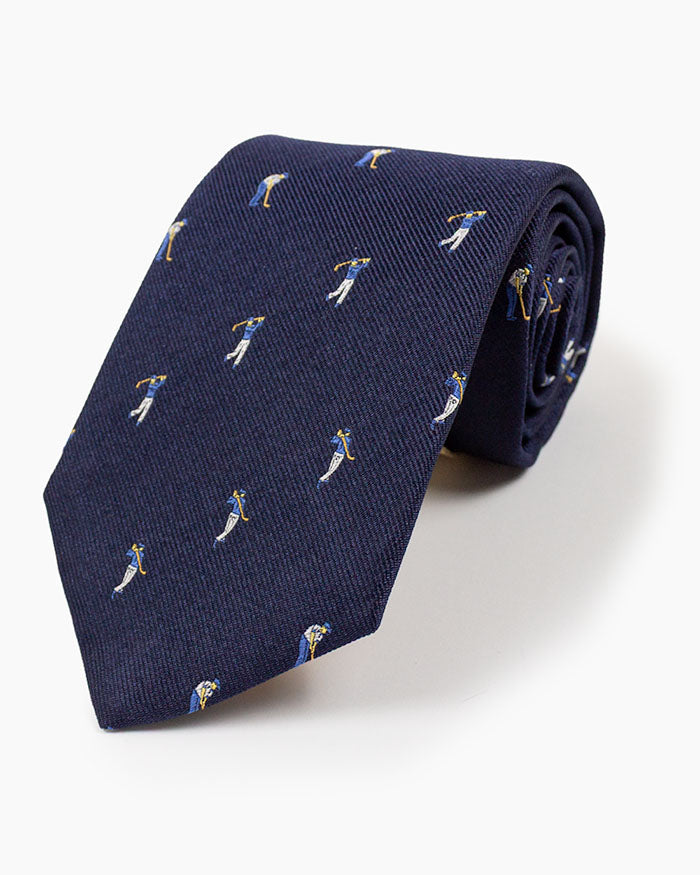 The Navy Golfer Tie features a distinctive golfer motif on rich navy silk, handmade in North Carolina with traditional craftsmanship.
