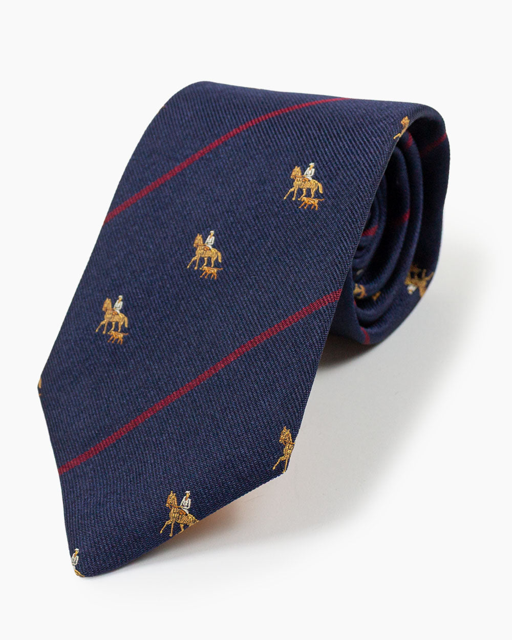 The Navy Hunting Tie features a distinctive hunting motif against a rich navy ground. Crafted from 100% silk and handmade in North Carolina, it brings traditional sporting character to classic American neckwear.