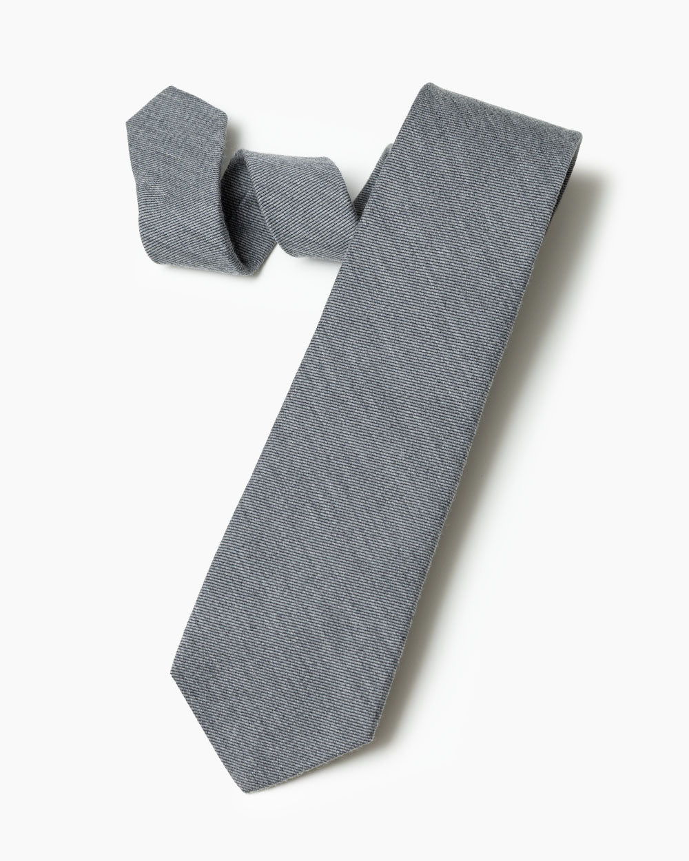The grey wool/silk tie with 70% wool and 30% silk hand sewn labels, loops and bar tack with a hand shaped form.